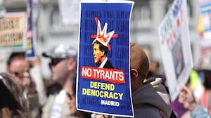 Demonstrators holding anti Donald Trump placards take part in a 'No Kings Day' protest in Madrid on March 28, 2026. The "No Kings" movement is a coalition of grassroots groups that has originally emerged in the United States as the biggest voice of national outrage against Trump since he began his second term in January 2025. (Photo by Thomas COEX / AFP via Getty Images)