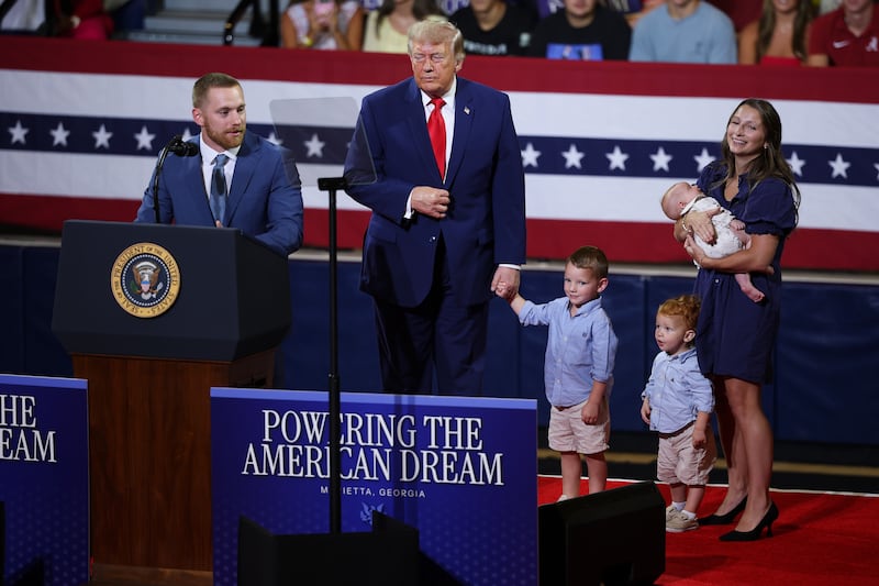 President Donald Trump invites a family on stage to speak about Trump Accounts during an event at Wheeler High School on July 22, 2026 in Marietta, Georgia.