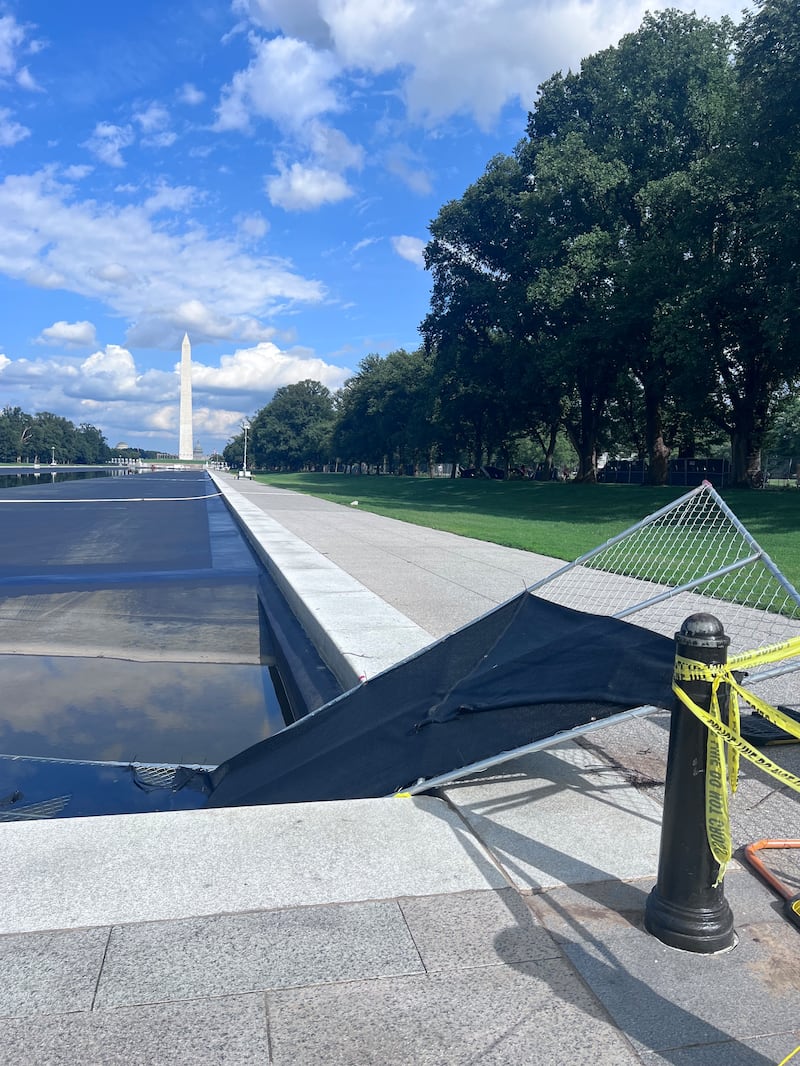 Fences, debris and storm water now fill the Reflecting Pool after a powerful storm ripped through DC.