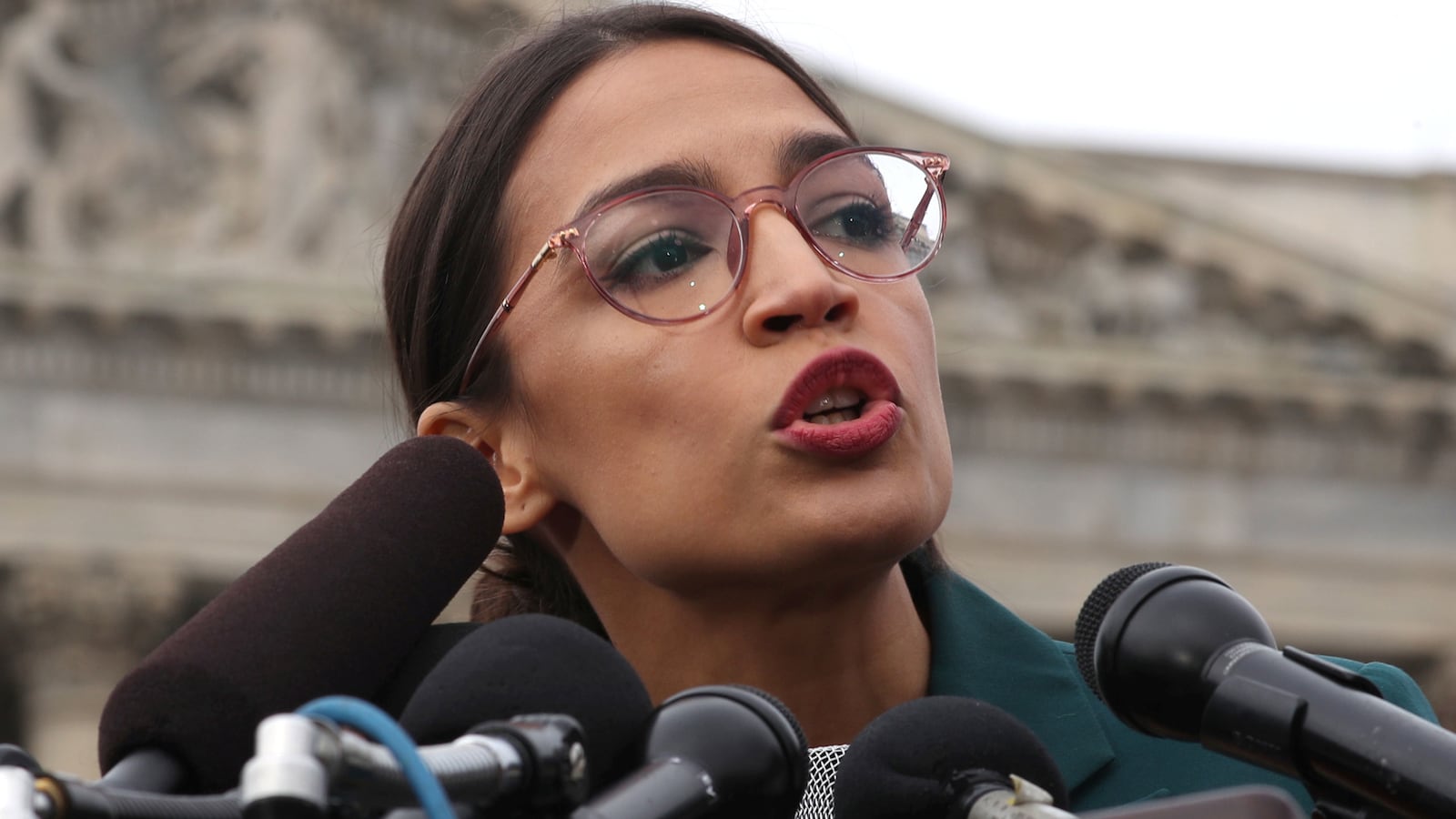 image of alexandra ocasio cortez speaking at capitol hill congress aoc green new deal ed markay resolution non binding environment climate change