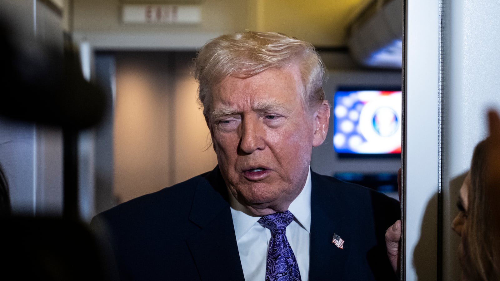 President Donald Trump speaks to the press aboard Air Force One
