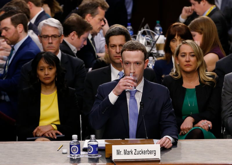 Facebook CEO Mark Zuckerberg takes a drink while testifying before a Senate Judiciary and Commerce Committees joint hearing regarding the company’s use and protection of user data on Capitol Hill