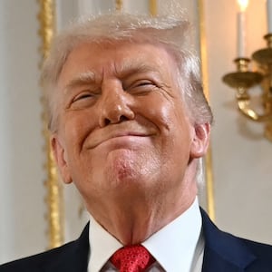 Donald Trump reacts as he arrives at a dedication ceremony for Southern Boulevard, in the ballroom at Mar-a-Lago in Palm Beach, Florida