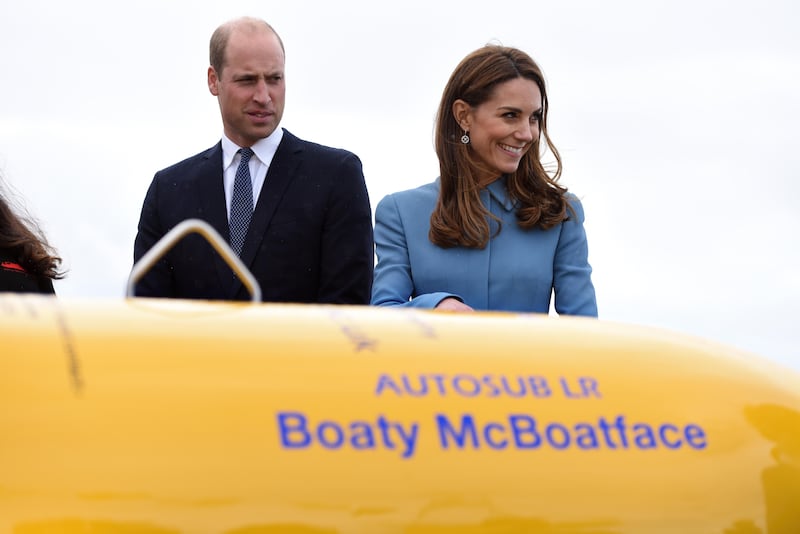 Britain's Catherine, Duchess of Cambridge (R) and Britain's Prince William, Duke of Cambridge react as they stand near the unmanned submarine 'Boaty McBoatface',