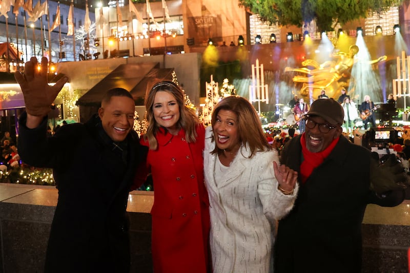 Craig Melvin, Savannah Guthrie, Hoda Kotb, and Al Roker pose for pictures during the 2024 Rockefeller Center Christmas Tree lighting ceremony.