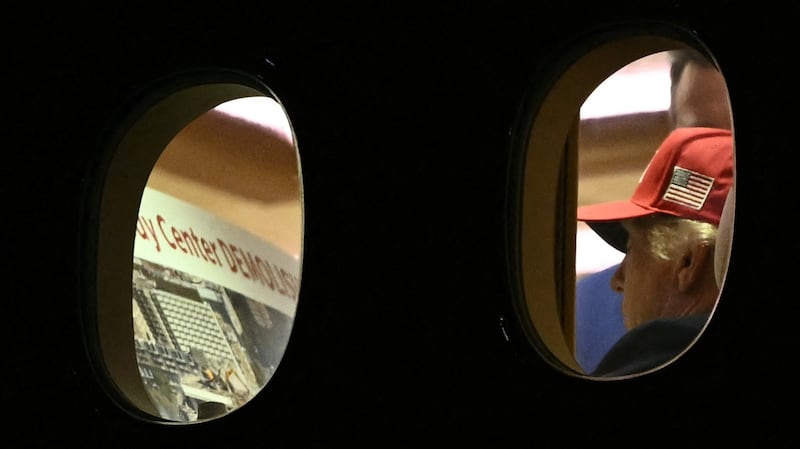 Donald Trump appears to be examining plans to "demolish" the Kennedy Center in this photo taken through the windows of Air Force One earlier this week.