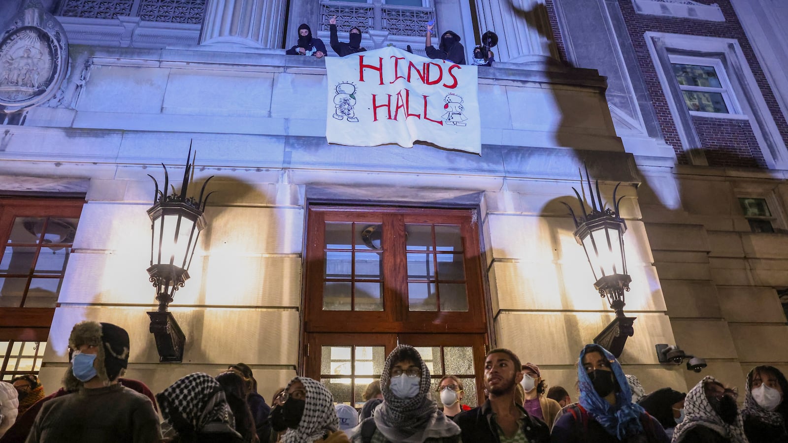 Protesters link arms outside Hamilton Hall barricading students inside the building at Columbia University in New York.