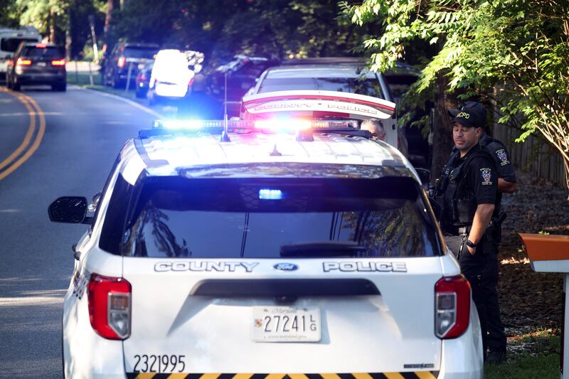 Police officers stand outside the home of the former White House national security adviser John Bolton as it is searched by FBI members, in Bethesda, MD on August 22, 2025.