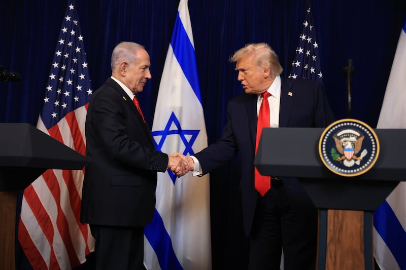 U.S. President Donald Trump shakes hands with Israeli Prime Minister Benjamin Netanyahu.