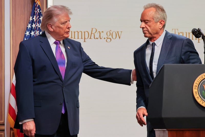 U.S. President Donald Trump and U.S. Health and Human Services Secretary Robert F. Kennedy Jr. interact during an event to deliver remarks about health care costs and affordability from an auditorium on the White House campus in Washington, D.C., U.S., May 18, 2026.
