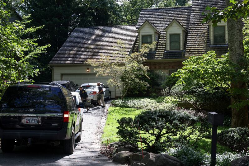 FBI members walk outside the home of the former White House national security adviser John Bolton as it is searched by FBI, in Bethesda, Maryland, Aug. 22, 2025.