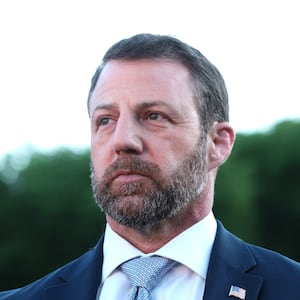 U.S. Secretary of Homeland Security Markwayne Mullin looks on as U.S. President Donald Trump speaks