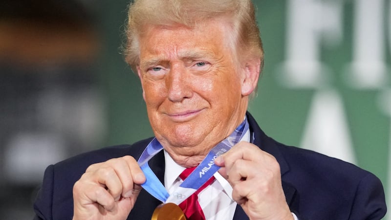 U.S. President Donald Trump holds a gold Olympic medal belonging to U.S. speed skater and Wisconsin native Jordan Stolz during an event at Custer Farms in Chippewa Falls, Wisconsin, U.S., June 5, 2026.