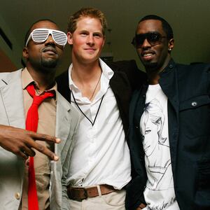 Kanye West (L) poses with Prince Harry (C) and US rapper P Diddy (R) at Wembley Arena in north London, 01 July 2007
