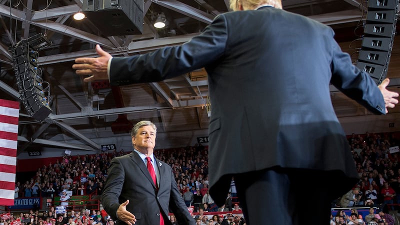 TOPSHOT - US President Donald Trump greets talk show host Sean Hannity at a Make America Great Again rally in Cape Girardeau, Missouri on November 5, 2018. (Photo by Jim WATSON / AFP) (Photo by JIM WATSON/AFP via Getty Images)