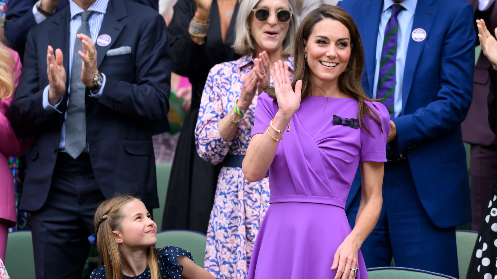 Catherine, Princess of Wales waves as she receives a standing ovation court-side of Centre Court during the men's final on day fourteen of the Wimbledon Tennis Championships on July 14, 2024 in London, England.