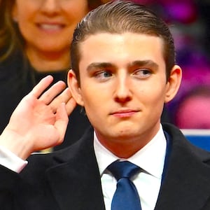 Barron Trump gestures after being acknowledged by his father US President Donald Trump during the inaugural parade inside Capital One Arena, in Washington, DC, on January 20, 2025.