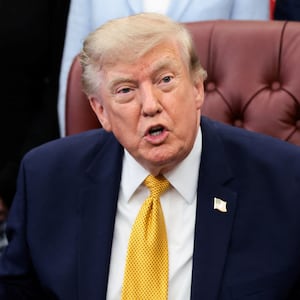 U.S. President Donald Trump answers questions from the media after signing an executive order establishing the President's Military Spouse Commission to be chaired by Jennifer Rauchet, wife of Secretary of Defense Pete Hegseth, in the Oval Office at the White House in Washington, D.C., U.S., August 3, 2026.