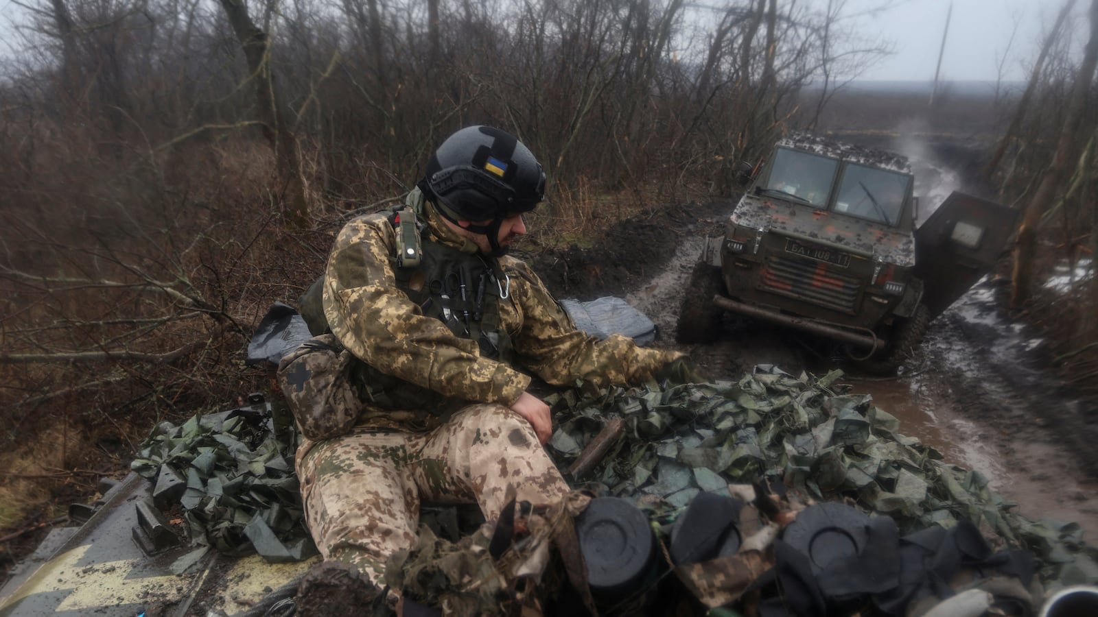 A Ukrainian service member rides atop of an infantry fighting vehicle near the frontline town of Bakhmut, Ukraine, Feb. 25, 2023.