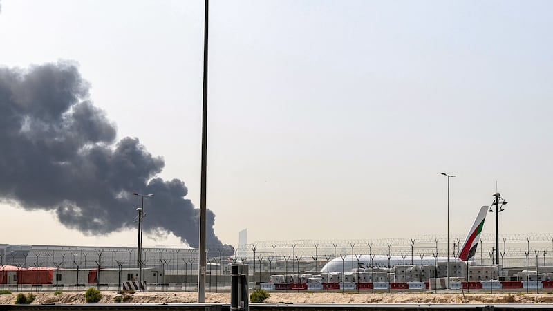 A smoke plume rises from an ongoing fire near Dubai International Airport in Dubai on March 16, 2026.