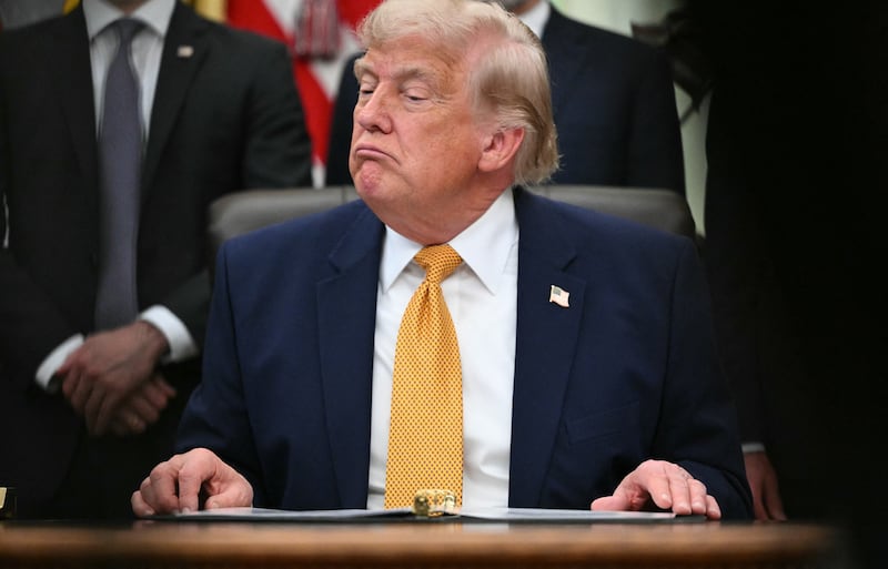 US President Donald Trump looks on after signing an executive order in the Oval Office of the White House in Washington, DC, on June 22, 2026.