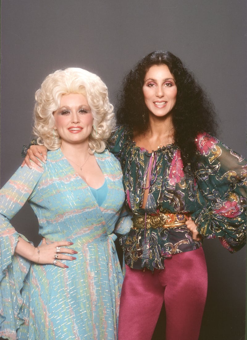 Singer and actress Cher poses with Dolly Parton for a portrait in 1978 in Los Angeles, California.