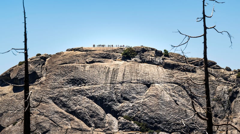 Visitors take in the views from the top of Moro Rock in Sequoia National Park, CA on Monday, June 30, 2025.