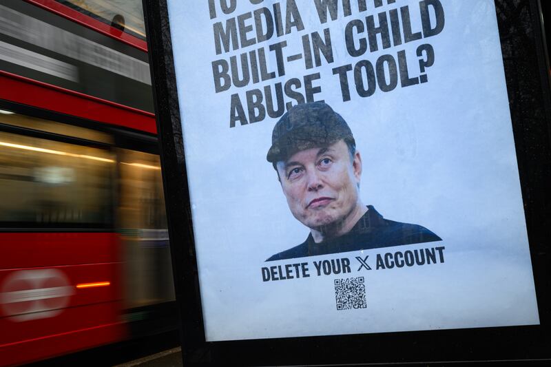 LONDON, ENGLAND - JANUARY 13: (EDITORS NOTE: Image contains profanity) An unofficially-installed poster picturing Elon Musk with the tagline, "Who the [expletive] would want to use social media with a built-in child abuse tool?" is displayed on a bus shelter on January 13, 2026 in London, England. Yesterday the UK communications regulator Ofcom launched a formal investigation into Elon Musk's social media platform X, regarding its AI chatbot, Grok. The probe centers on reports that Grok has been used to generate non-consensual sexual deepfakes, including "undressed" images of women and sexualized images of children. The activist group Everyone Hates Elon has created a series of posters and public artworks in recent months critical of Elon Musk, as well as other business and political leaders.  (Photo by Leon Neal/Getty Images)