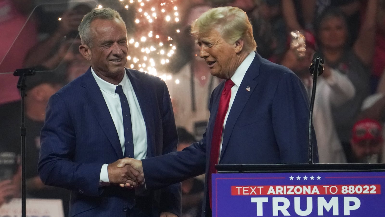 Robert F. Kennedy Jr. shakes hands with Donald Trump on stage.