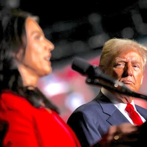Donald Trump looks at Tulsi Gabbard as she speaks at a campaign rally in Greensboro, North Carolina, U.S. October 22, 2024.