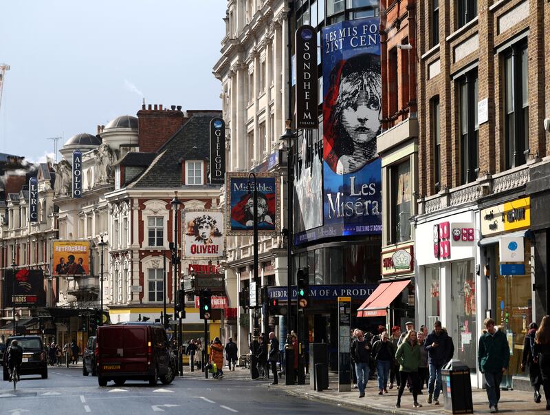 People walk along Shaftesbury Avenue in the West End of London, Britain, March 13, 2025. REUTERS/Isabel Infantes
