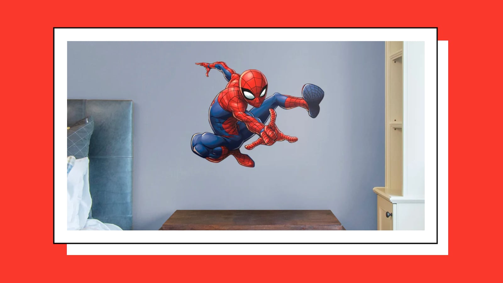 Wall decal of Spider-Man mid-swing, sticking to a bedroom wall above a headboard.
