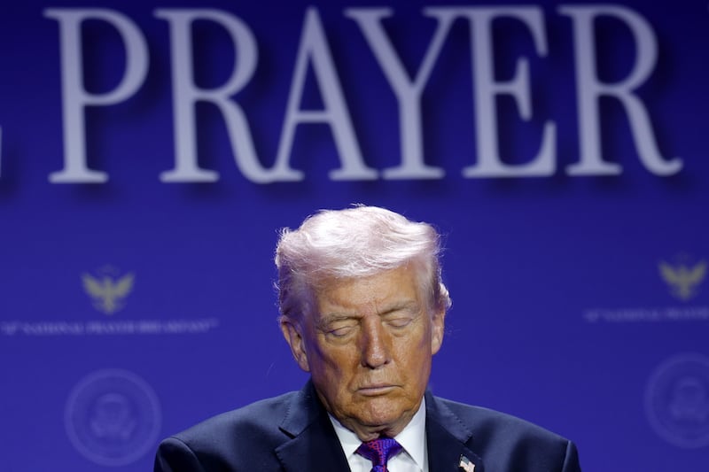 WASHINGTON, DC - FEBRUARY 05:  U.S. President Donald Trump bows his head in prayer during the 74th annual National Prayer Breakfast at the Washington Hilton on February 5, 2026 in Washington, DC. President Trump is joined by bipartisan Congressional members, business, and religious leaders to pray for the nation. (Photo by Alex Wong/Getty Images)