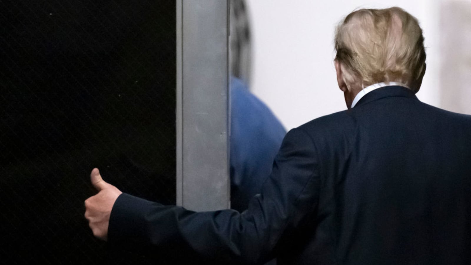 Former U.S. President Donald Trump gestures as he leaves court during his hush money trial.