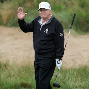 President Donald Trump holds a driver after teeing off during the opening of his new golf course at his Trump International Golf links resort on July 29, 2025 in Balmedie, Scotland. President Trump is visiting Scotland in a trip that’s part-vacation, part-work, as he stayed at his Trump Turnberry golf course, followed by Trump International Golf Links in Aberdeenshire, between July 25 to 29.