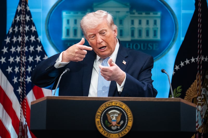 President Donald Trump mimics firing a gun during a news conference in the White House briefing room about the war in Iran on Monday, April 6, 2026.