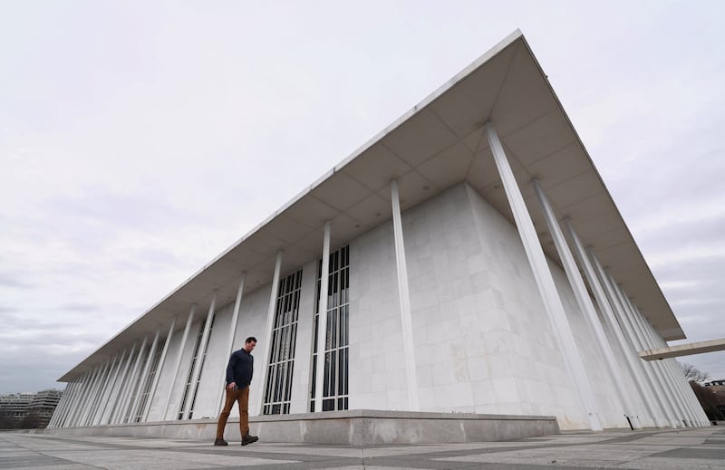 A man walks by the John F. Kennedy Center for the Performing Arts, after White House spokeswoman Karoline Leavitt announced that the Kennedy Center board decided to rename the institution the Trump-Kennedy Center in Washington, D.C., U.S., December 18, 2025.