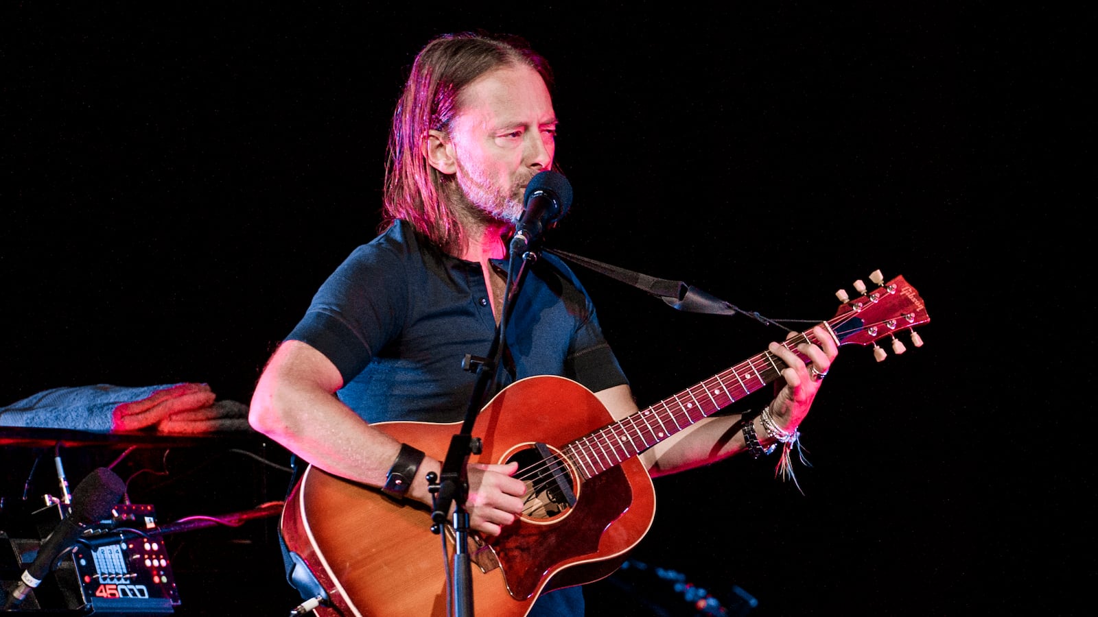 Thom Yorke performs at a concert.