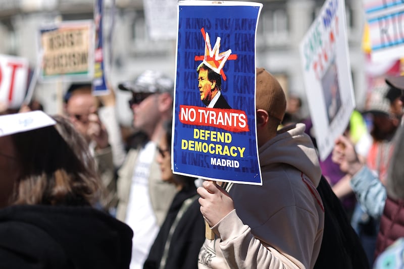 Demonstrators holding anti Donald Trump placards take part in a 'No Kings Day' protest in Madrid on March 28, 2026. The "No Kings" movement is a coalition of grassroots groups that has originally emerged in the United States as the biggest voice of national outrage against Trump since he began his second term in January 2025. (Photo by Thomas COEX / AFP via Getty Images)