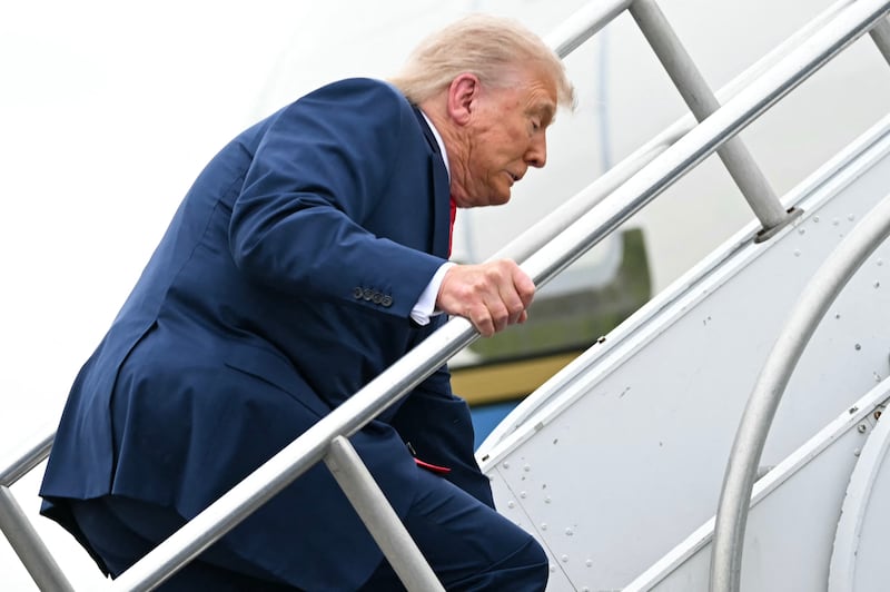 US President Donald Trump trips while boarding Air Force One prior to departure from Morristown Municipal Airport in Morristown, New Jersey, on June 8, 2025, en route to Camp David. (Photo by ANDREW CABALLERO-REYNOLDS / AFP) (Photo by ANDREW CABALLERO-REYNOLDS/AFP via Getty Images)