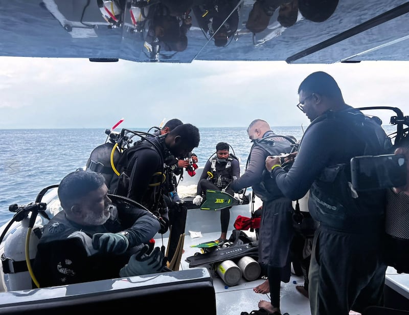 Divers preparing to search for the bodies of missing Italian divers in the Maldives