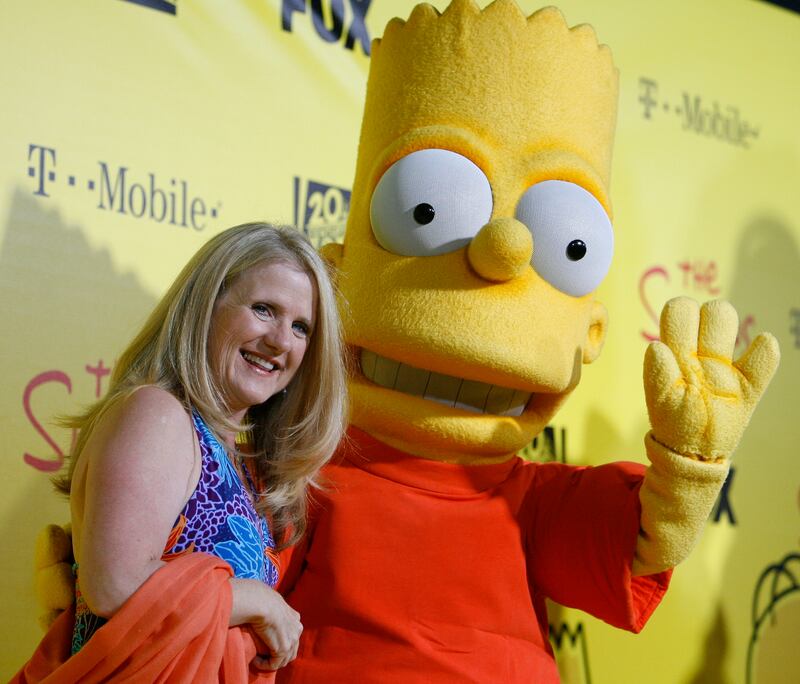 Actress Nancy Cartwright, who gives Bart's voice, poses with the character from "The Simpsons" at the 20th anniversary party for the television series at Barker hangar in Santa Monica, California October 18, 2009.    REUTERS/Mario Anzuoni   (UNITED STATES ENTERTAINMENT)