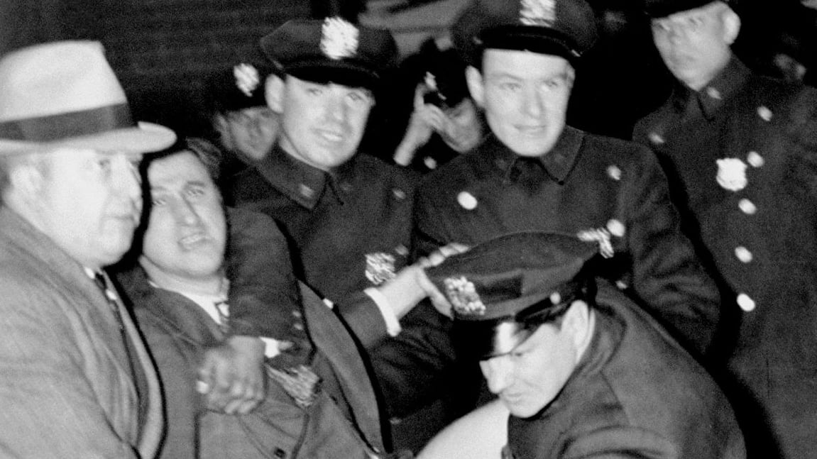 Police arrest Isidore Greenbaum during a Nazi meeting at Madison Square Garden.