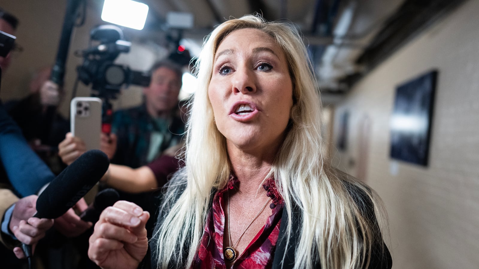 Rep. Marjorie Taylor Greene talks with reporters a meeting of the House Republican Conference in the U.S. Capitol on Tuesday, April 8, 2025.