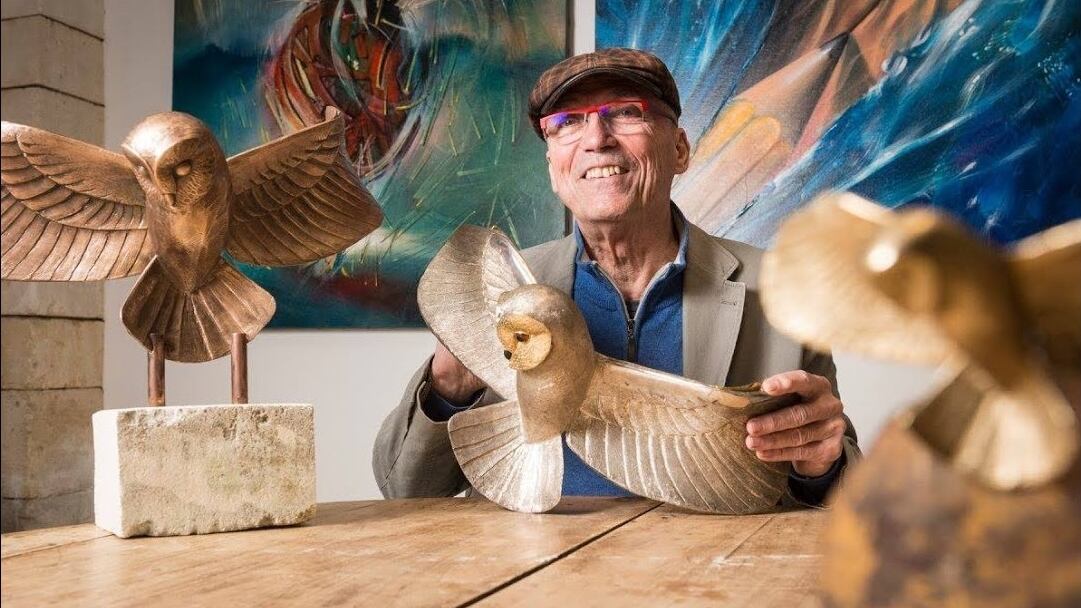 Michel Becker poses with models of the Golden Owl statuette at the centre of a 31 year long treasure hunt.