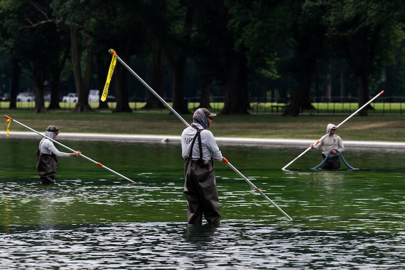 Members of the National Park Service clean the Lincoln Memorial Reflecting Pool after recent renovations following a directive from U.S. President Donald Trump to paint it blue ahead of the 250th anniversary of U.S. Independence, in Washington, D.C., U.S., June 18, 2026.