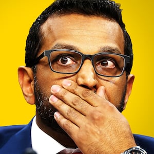 Kash Patel with his hand over his mouth.