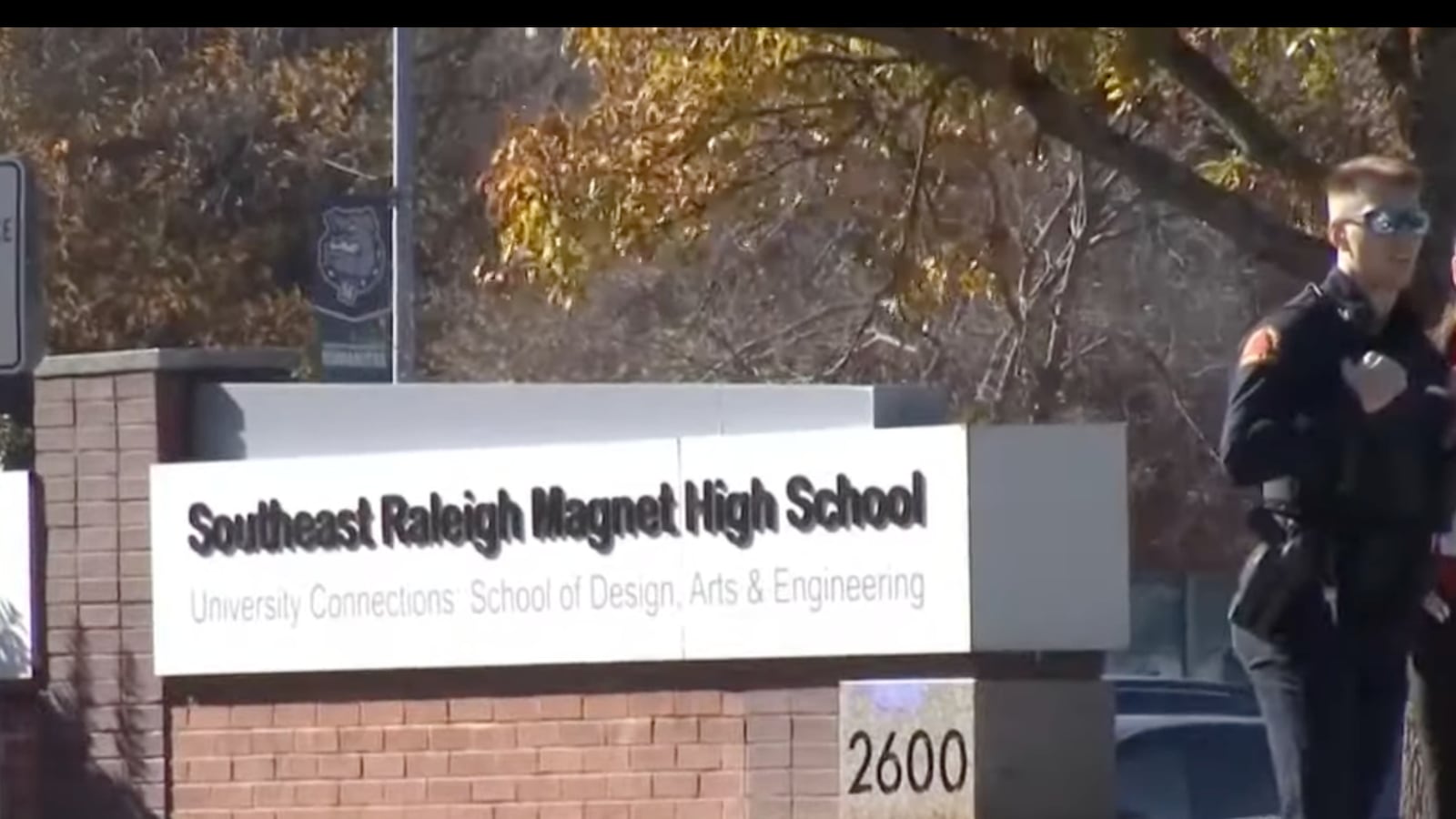 A police officer stands in front of South Raleigh High School