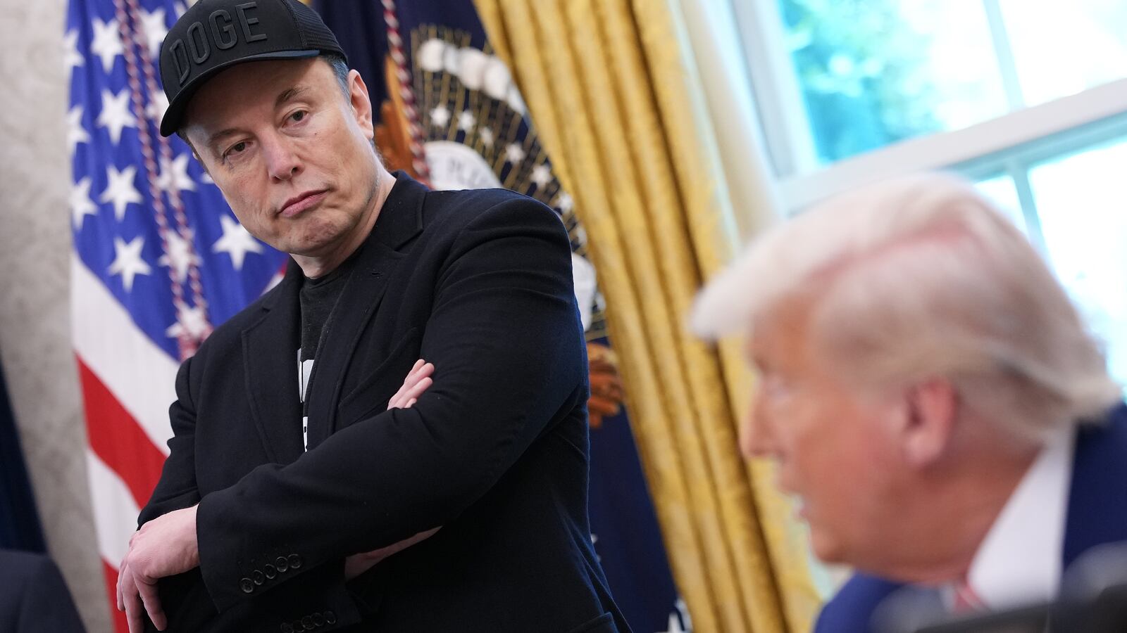 WASHINGTON, DC - MAY 30: Tesla CEO Elon Musk listens as U.S. President Donald Trump speaks to reporters in the Oval Office of the White House on May 30, 2025 in Washington, DC. Musk, who served as an adviser to Trump and led the Department of Government Efficiency, announced he would leave his role the Trump administration to refocus on his businesses. (Photo by Kevin Dietsch/Getty Images)