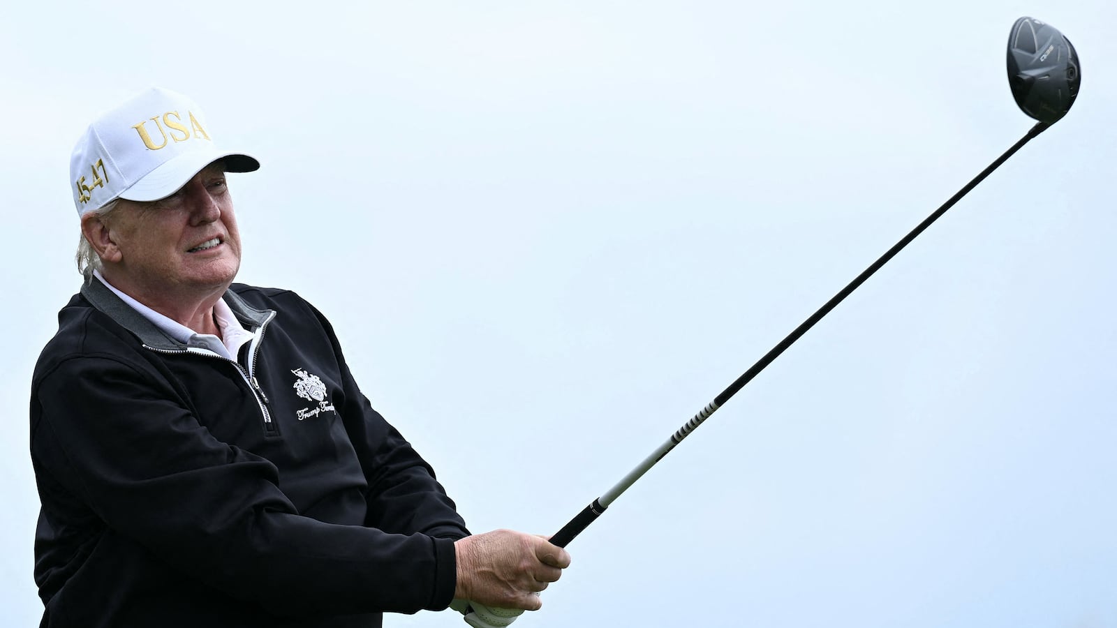 TOPSHOT - US President Donald Trump watches his drive after playing from the first tee to officially open the Trump International Golf Links course in Balmedie, Aberdeenshire, north east Scotland on July 29, 2025. (Photo by Brendan SMIALOWSKI / AFP) (Photo by BRENDAN SMIALOWSKI/AFP via Getty Images)